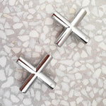 Clark Cross chrome wall top tap handles, shown as a pair on a stone surface