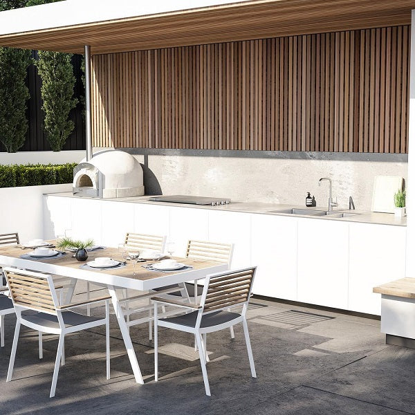 Caroma Compass Alfresco stainless steel gooseneck sink mixer in an outdoor kitchen, hob mounted on a benchtop.