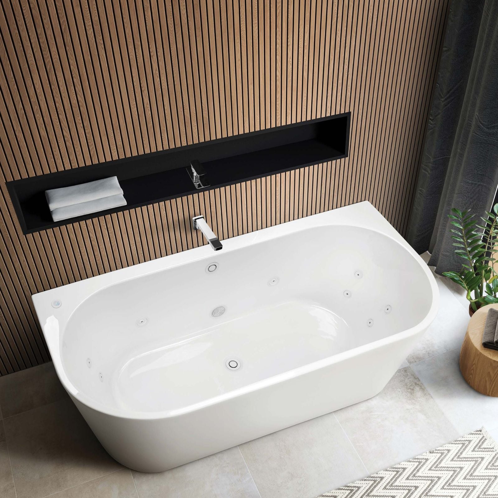 Decina Alegra white oval back-to-wall spa bath with white jets, shown in a modern bathroom setting