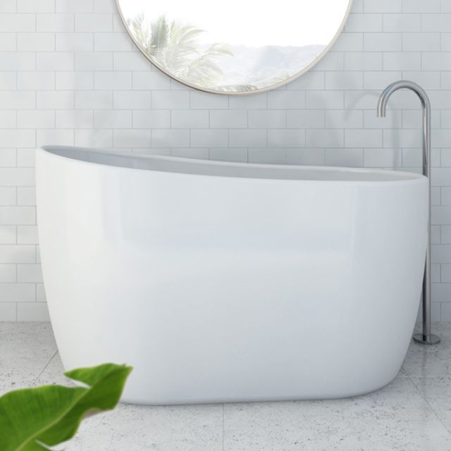 Decina Cosmo white freestanding oval bath with integrated overflow, shown in a modern bathroom setting