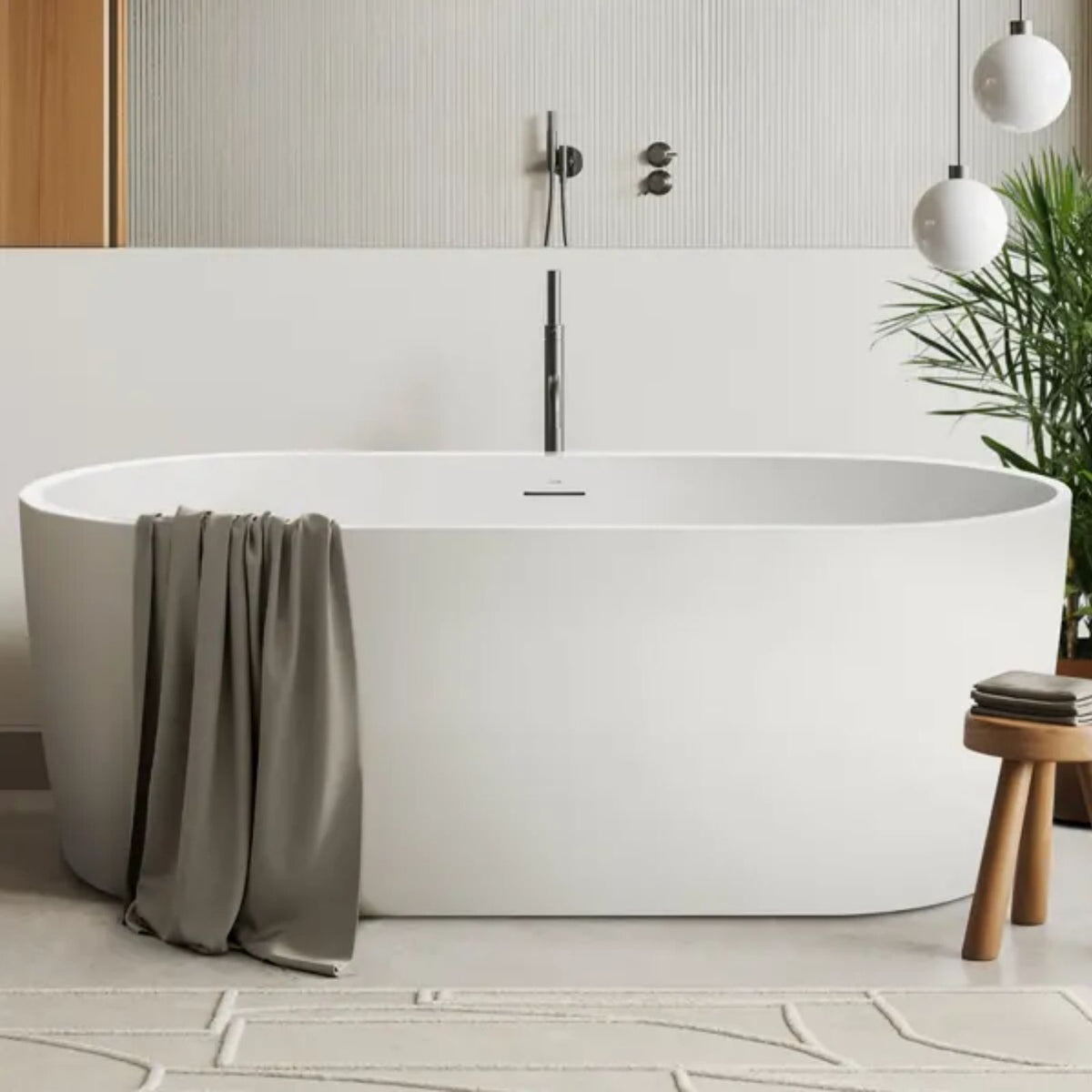 Decina Elisi white oval freestanding bath in a modern bathroom, with integrated overflow and centre waste opening visible