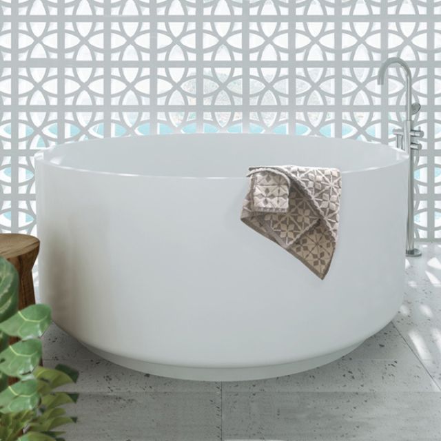 Decina Florencia white round freestanding bath with integrated overflow, shown in a bathroom setting