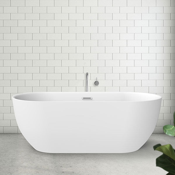 Decina Valentina freestanding bath, oval matte white acrylic tub in bathroom setting, front view with wall tiles and tapware