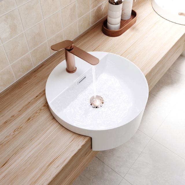 Fienza Empire Slim brushed copper basin mixer on a white round countertop basin in a modern bathroom vanity setting