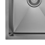 Close-up of a Fienza Hana gun metal kitchen sink corner, showing textured stainless steel bowl, rim and basket waste detail