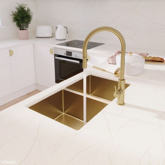 Fienza Hana double bowl kitchen sink in rugged brass, topmount or undermount, shown in a white benchtop kitchen with gold mixer tap