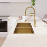 Fienza Hana double bowl kitchen sink in rugged brass, undermount in white benchtop, with gold gooseneck mixer tap