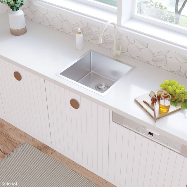 Fienza Hana stainless steel single bowl kitchen sink in a white benchtop, topmount view with mixer tap and drainer tray
