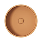 Fienza Jada round above-counter basin in Tuscan concrete, shown from above with a central waste hole