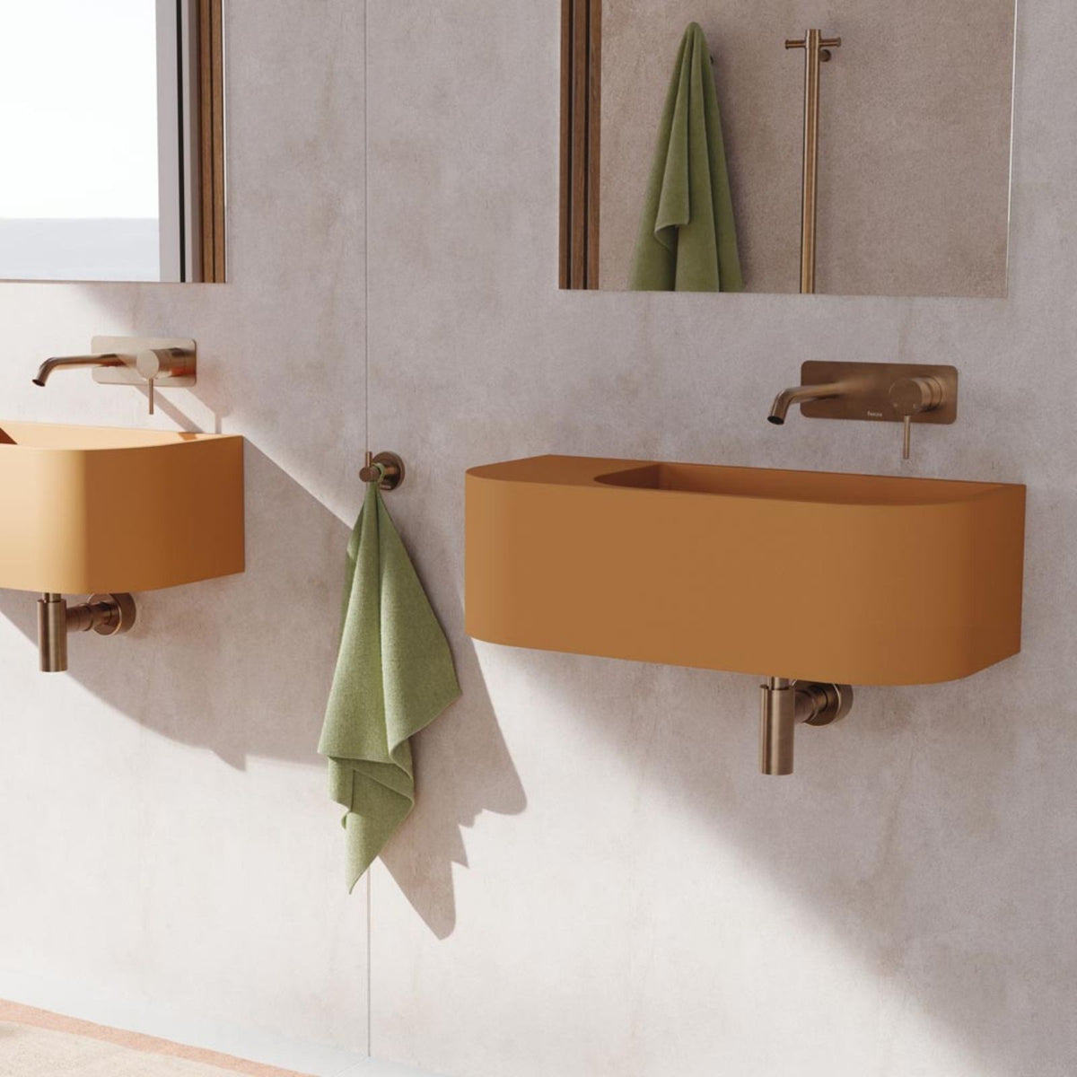 Fienza Kaya brushed copper wall basin mixer with round plate and curved outlet, shown in a modern bathroom with terracotta basins