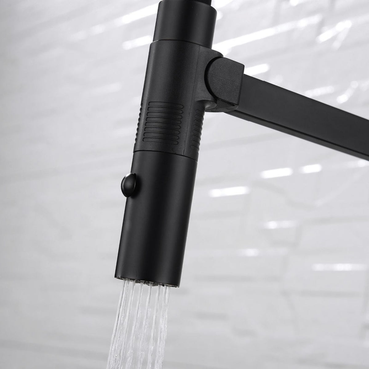 Fienza Kaya pull down sink mixer in matte black with water flowing from the detachable spray head