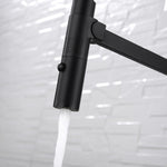 Fienza Kaya pull down sink mixer in gun metal, close-up of the nozzle with water flowing and swivel arm attached