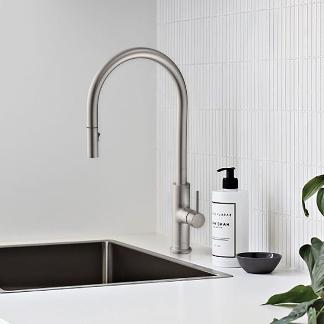 Fienza Kaya pull out sink mixer in brushed nickel, gooseneck swivel tap over a kitchen sink with lever handle