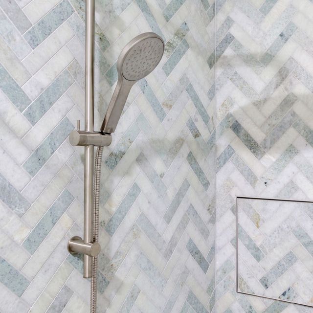 Fienza Kaya rail shower in brushed nickel, shown installed against patterned bathroom tiles