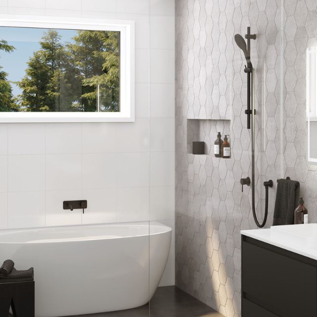 Fienza Kaya rail shower in matte black, shown in a modern bathroom beside a freestanding bath and tiled wall.