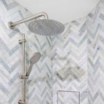 Fienza Kaya brushed nickel shower arm with round shower head in a tiled bathroom wall setting
