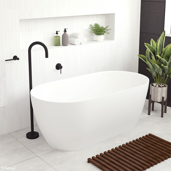 Fienza Kaya slim wall freestanding stone bath in matte white, oval 1500mm, styled in a modern bathroom
