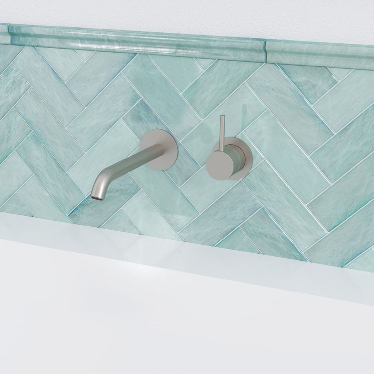 Fienza Kaya wall basin/bath mixer set in brushed nickel, shown mounted on aqua herringbone tiles