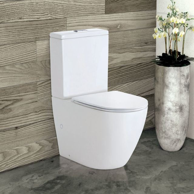 Fienza Koko back-to-wall toilet suite in gloss white with slim seat, shown in bathroom setting, front angle.