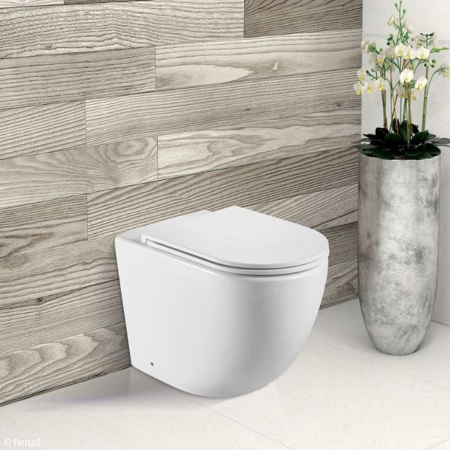 Fienza Koko wall-faced toilet suite in matte white with slim seat, shown in a modern bathroom setting