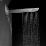 Fienza Komo chrome wall mounted overhead sheet shower with wide rectangular water flow in a dark bathroom setting