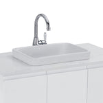 Fienza Eleanor chrome gooseneck basin mixer with white ceramic handle, shown mounted behind a basin on a vanity countertop