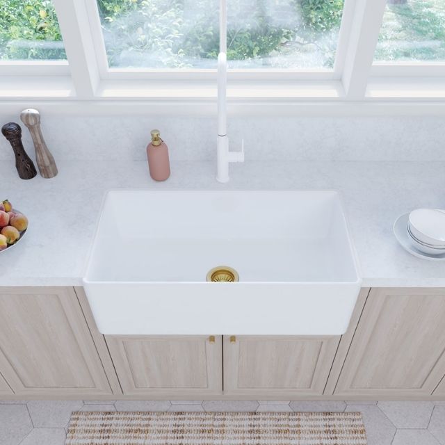 Fienza Olivia Large 835 reversible butler sink in gloss white fire clay, shown installed in a bright kitchen