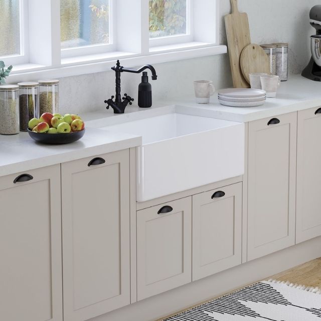 Fienza Olivia white fire clay butler sink with fluted front in a light kitchen bench setting