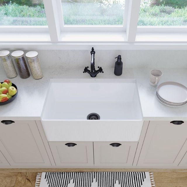 Fienza Olivia gloss white butler sink with flat front, single bowl fire clay ceramic, installed under a light stone benchtop