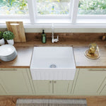 Fienza Olivia small reversible butler sink in gloss white fire clay, fluted front shown in a kitchen bench installation