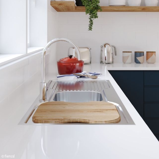 Fienza Tiva oak sink chopping board over stainless steel sink in white kitchen bench