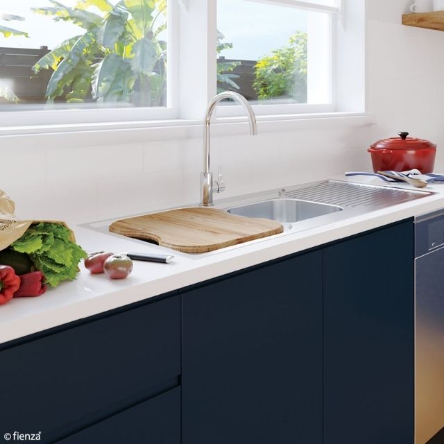 Fienza Tiva oak chopping board over sink, treated timber, on a kitchen benchtop with stainless steel sink and tap