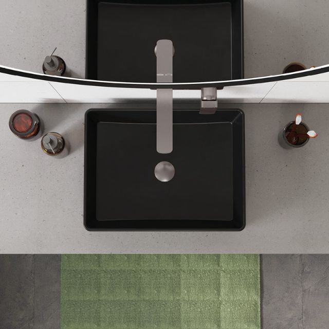 Fienza Tono gun metal wall basin/bath mixer set with 200mm outlet and rectangular plate above a black basin and mirror