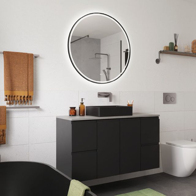 Fienza Tono gun metal wall basin mixer set above a black vanity and basin in a modern bathroom scene