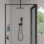 Fienza Tono matte black hand shower with soft square wall plate, wall-mounted in a modern shower recess with hose and holder.