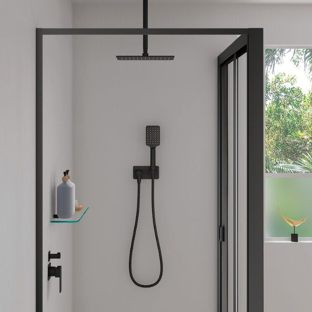 Fienza Tono matte black hand shower with soft square wall plate, wall-mounted in a modern shower recess with hose and holder.