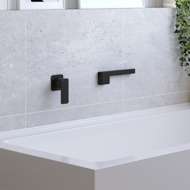 Fienza Tono matte black swivel bath outlet shown in a bathroom above a bath, with wall mixer beside it