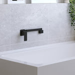 Fienza Tono matte black swivel bath spout mounted on a tiled wall above a white bath
