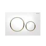 Geberit Sigma 20 dual flush plate in white with gold trim, with two circular buttons on a square wall plate