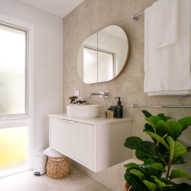 Matt white rectangular bathroom pedal bin beside a vanity in a modern bathroom setting