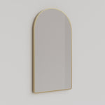 Ingrain arch wall mirror with brushed gold frame above a bathroom vanity, portrait view