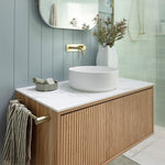Ingrain Grooved wall hung vanity with fluted woodgrain front, white top and round basin in a modern bathroom setting