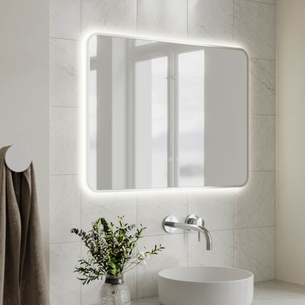 Ingrain rectangular brushed nickel framed backlit LED mirror in a bathroom, wall hung above a basin, landscape view