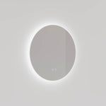 Ingrain round frameless backlit LED mirror with soft halo lighting, wall mounted against a light grey wall