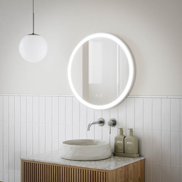 Ingrain round brushed nickel framed frontlit LED mirror above a bathroom vanity, lit white ring glow