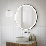 Ingrain round matte black framed frontlit LED mirror above bathroom vanity, wall hung with glowing light around the edge