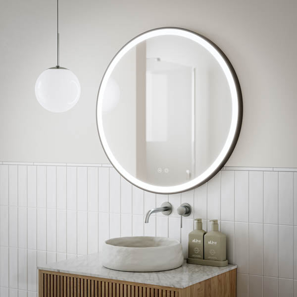 Ingrain round matte black framed frontlit LED mirror above bathroom vanity, wall hung with glowing light around the edge