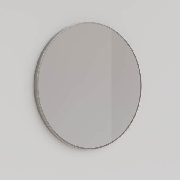 Ingrain round brushed nickel framed mirror, wall-mounted in a simple side view on a light wall