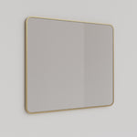 Ingrain rectangular mirror with brushed gold frame above a bathroom vanity, landscape wall-hung view