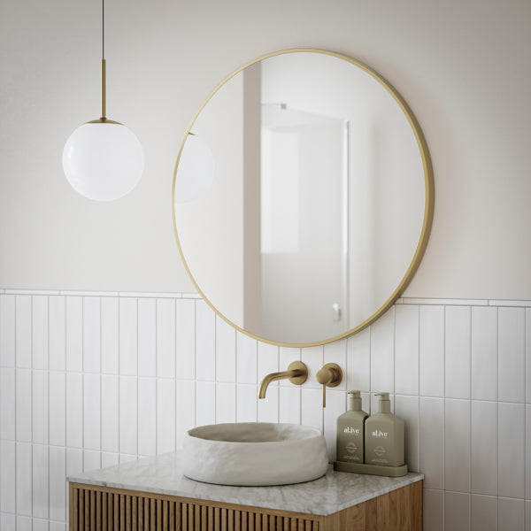 Ingrain round brushed gold framed mirror above a bathroom vanity, 800mm, wall hung